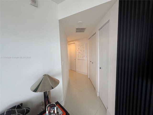 hallway with light tile patterned floors and visible vents