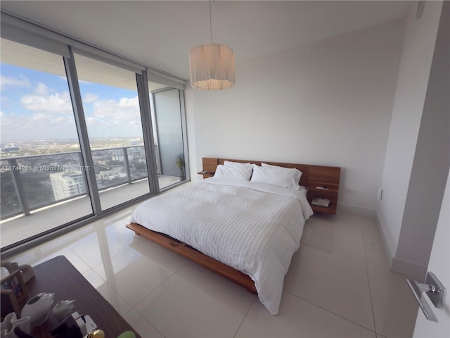 bedroom with access to exterior, tile patterned flooring, baseboards, and a wall of windows