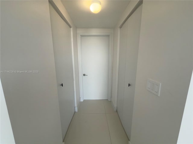 hallway featuring light tile patterned flooring