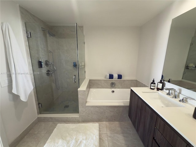 full bath featuring a garden tub, a shower stall, tile patterned floors, and vanity