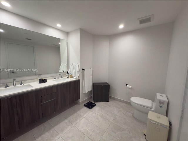 full bathroom featuring visible vents, a sink, toilet, and double vanity