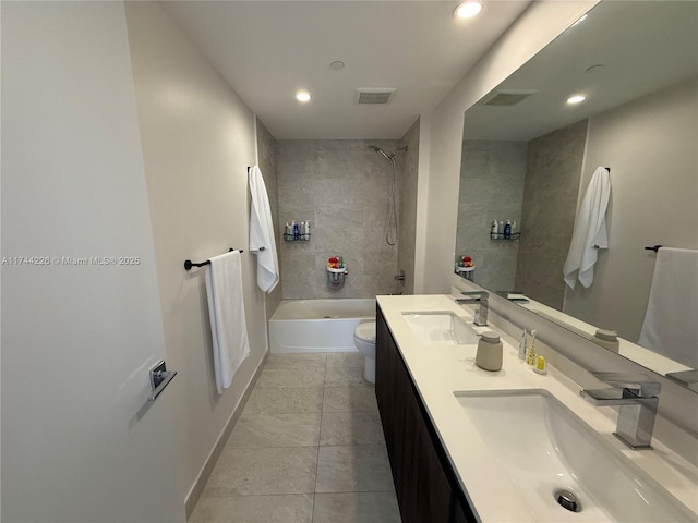 bathroom featuring visible vents, shower / bathing tub combination, a sink, and toilet