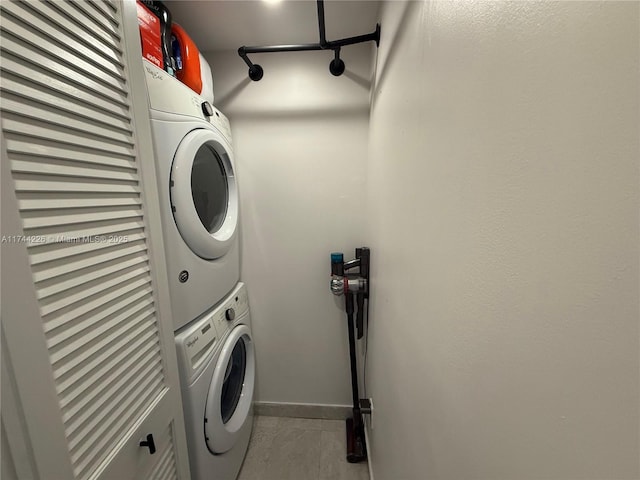 laundry room featuring laundry area and stacked washer / drying machine