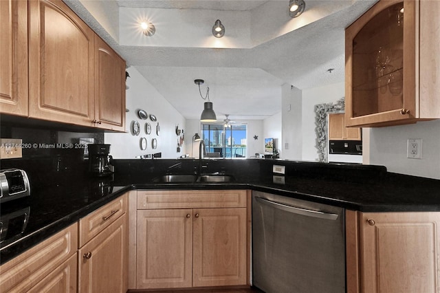 kitchen with pendant lighting, sink, dark stone counters, stainless steel dishwasher, and ceiling fan