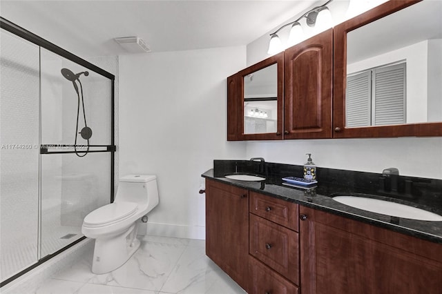 bathroom with vanity, a shower with shower door, and toilet