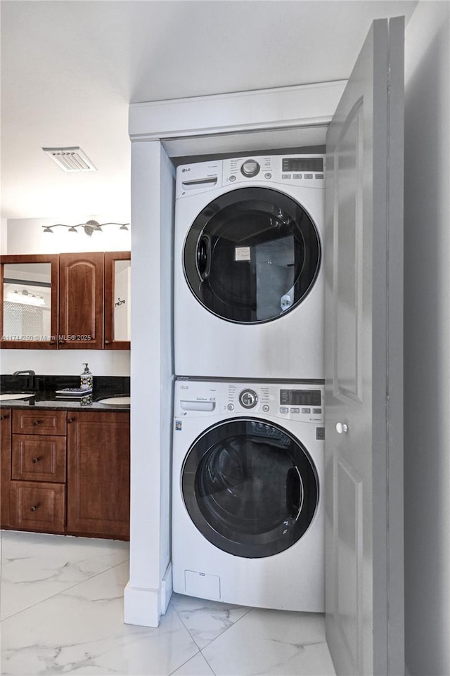 clothes washing area with stacked washer / drying machine