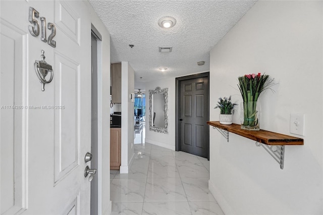 hallway with a textured ceiling