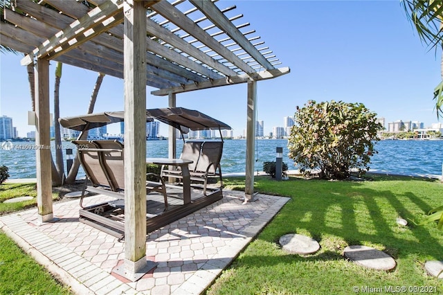 view of yard with a pergola and a water view