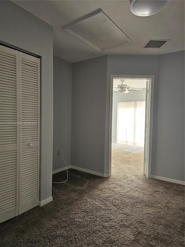 hallway with dark colored carpet