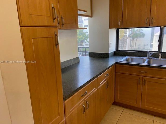 kitchen with sink and light tile patterned floors