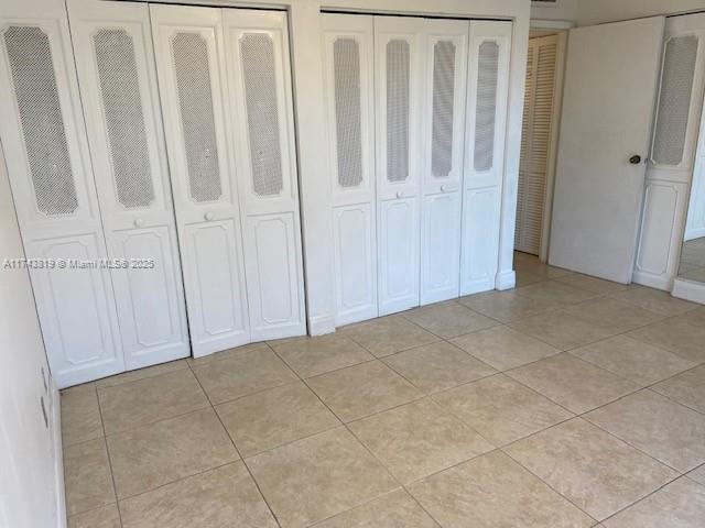 unfurnished bedroom featuring light tile patterned floors