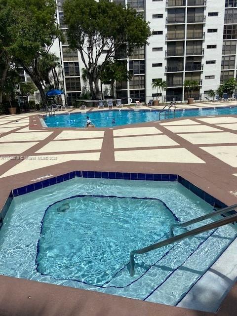 view of pool featuring a hot tub