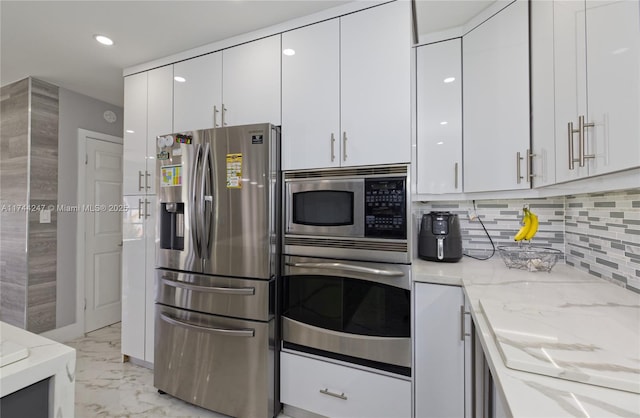 161 NW 46th Ter, Plantation, FL 33317 - kitchen featuring marble finish floor, appliances with stainless steel finishes, white cabinetry, and light stone countertops