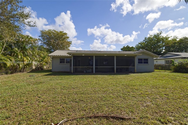 161 NW 46th Ter, Plantation, FL 33317 - back of house with stucco siding, a lawn, and a sunroom