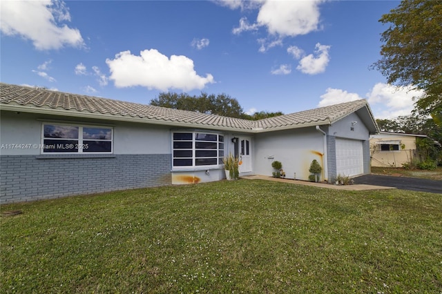 161 NW 46th Ter, Plantation, FL 33317 - single story home featuring driveway, a front yard, a garage, brick siding, and a tiled roof