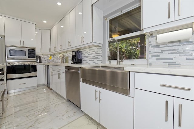 161 NW 46th Ter, Plantation, FL 33317 - kitchen with a sink, decorative backsplash, appliances with stainless steel finishes, white cabinetry, and marble finish floor
