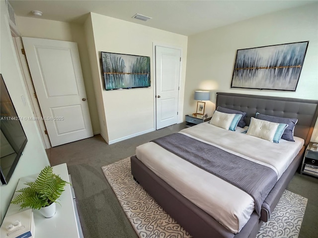 bedroom with dark colored carpet