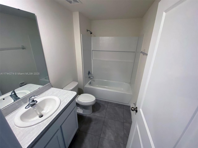 full bathroom with vanity, tile patterned floors, washtub / shower combination, and toilet