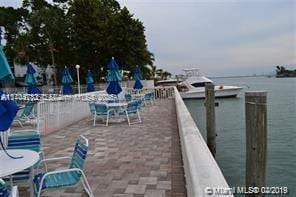 dock area featuring a water view and a patio area