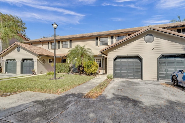 view of front of home with a garage and a front lawn