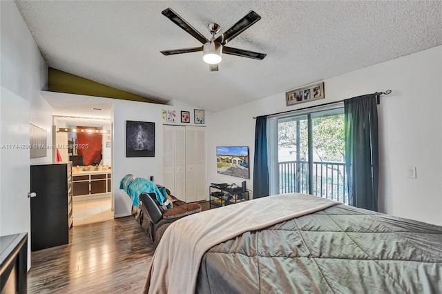 9007 Vineyard Lake Dr Unit 9007, Plantation, FL 33324 - bedroom with access to exterior, a textured ceiling, vaulted ceiling, and wood-type flooring