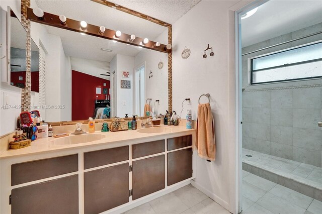 9007 Vineyard Lake Dr Unit 9007, Plantation, FL 33324 - bathroom with vanity, tile patterned flooring, a textured ceiling, and a tile shower
