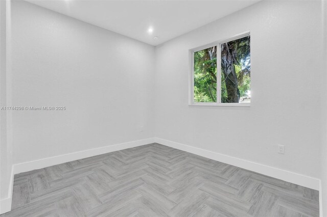 unfurnished bedroom featuring a closet and light parquet floors