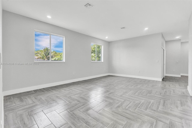 unfurnished room with light parquet flooring