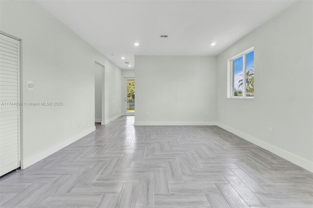 spare room with light parquet floors