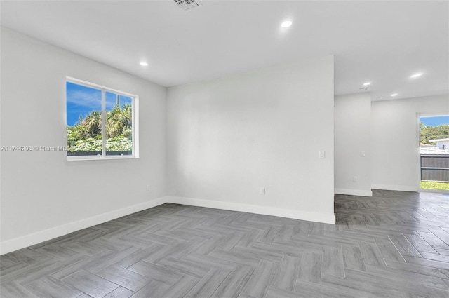 unfurnished room with light parquet flooring