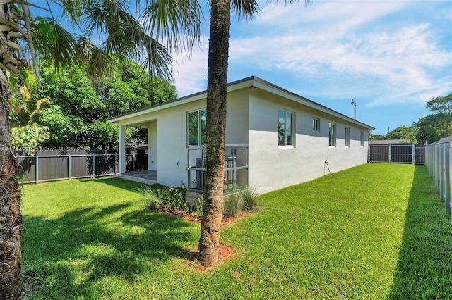 view of side of property with a yard