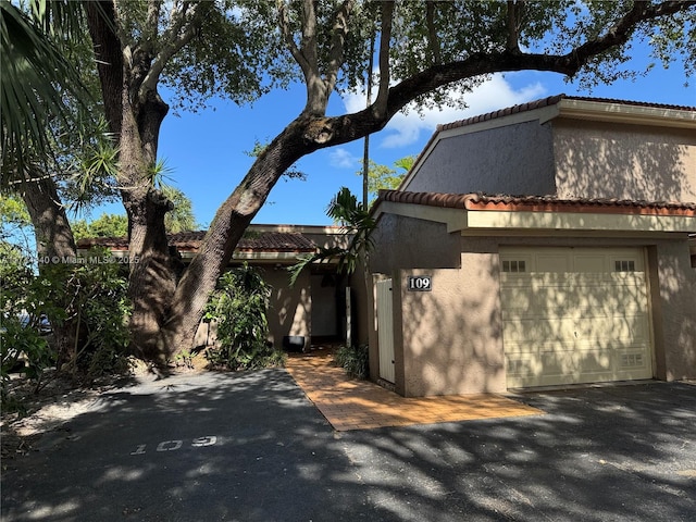 109 Heatherbrook Way Unit 146, Hollywood, FL 33021 - view of front of home featuring a garage, a tile roof, and stucco siding