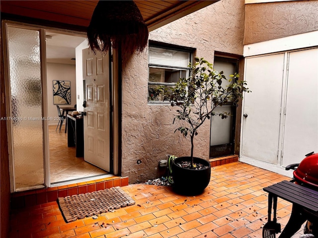 doorway to property with a patio area