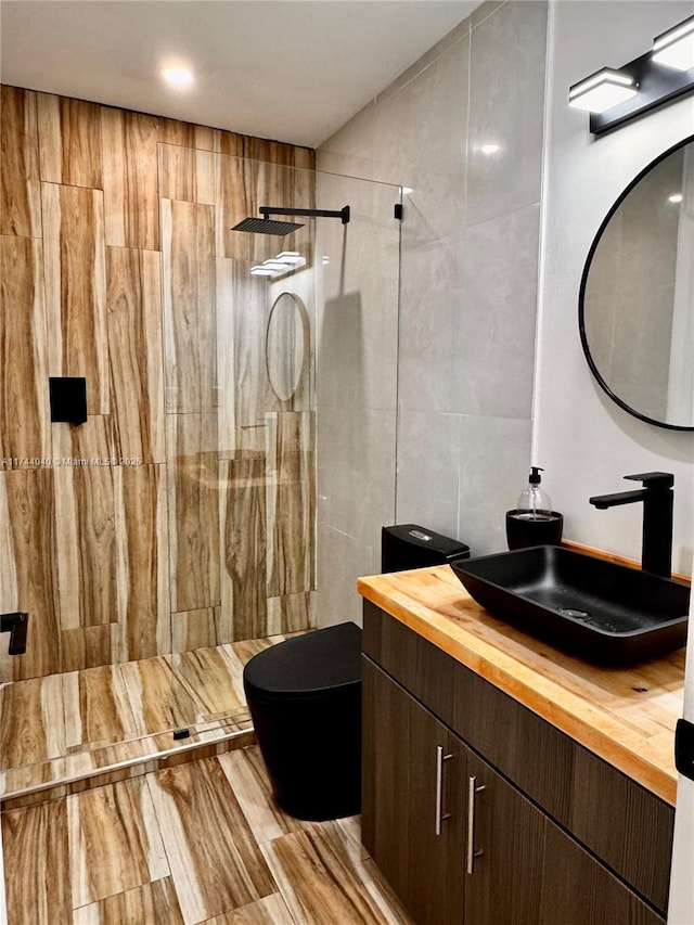 109 Heatherbrook Way Unit 146, Hollywood, FL 33021 - bathroom featuring vanity, tile walls, toilet, and tiled shower