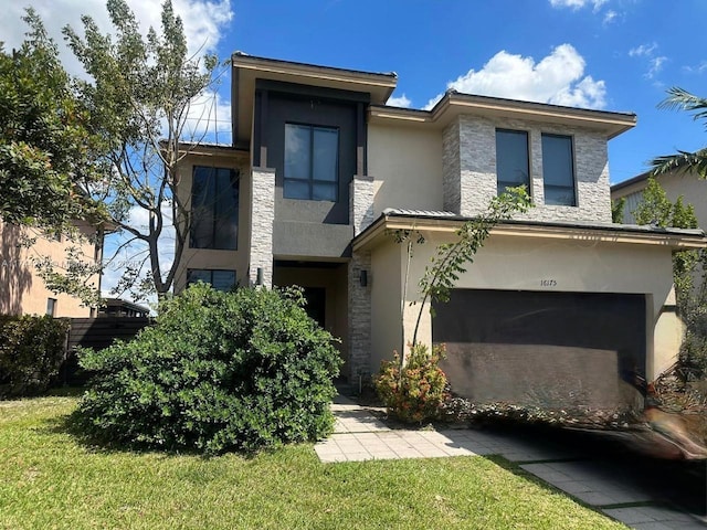 view of front of home featuring a front yard, an attached garage, stone siding, and stucco siding