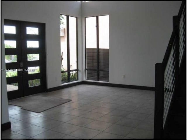 entryway with french doors and baseboards