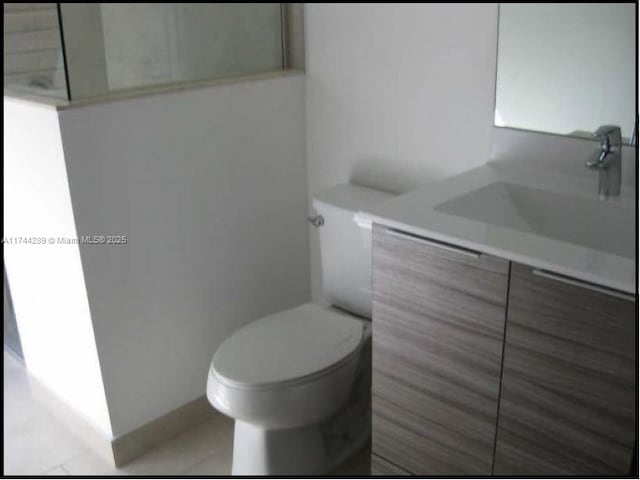 bathroom featuring toilet and vanity