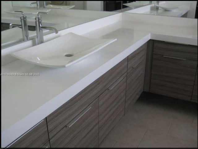 bathroom with tile patterned flooring and vanity