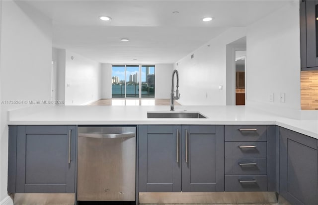 kitchen with gray cabinets, dishwasher, and sink