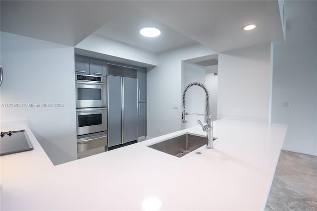 kitchen featuring sink, paneled refrigerator, black electric cooktop, kitchen peninsula, and stainless steel double oven