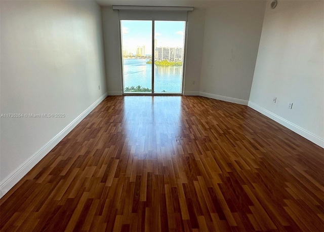 empty room with dark hardwood / wood-style floors