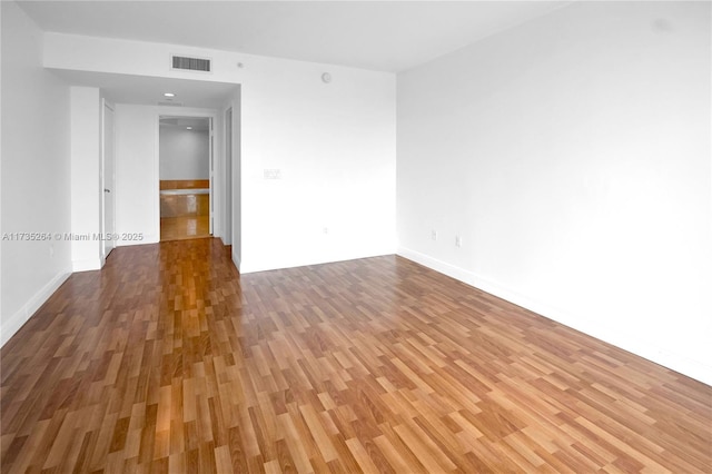 unfurnished room with wood-type flooring