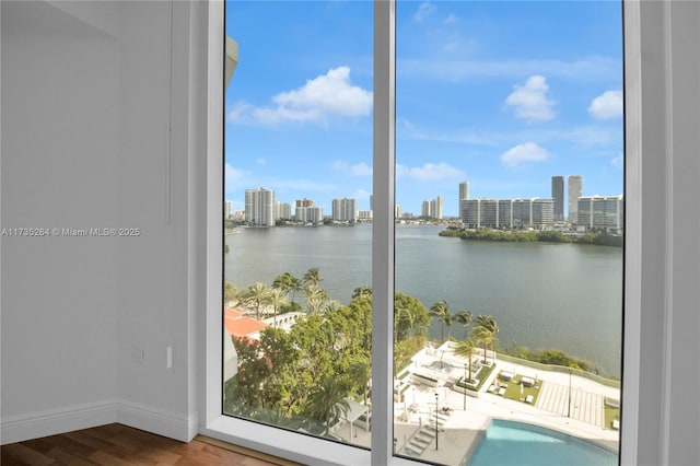 doorway to outside with a water view and hardwood / wood-style flooring