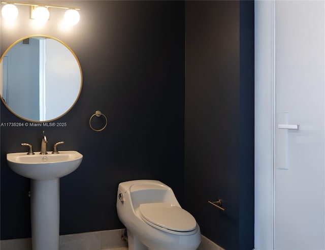 bathroom featuring toilet and sink