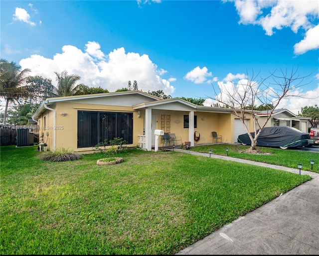 single story home featuring an attached garage, stucco siding, fence, and a front yard