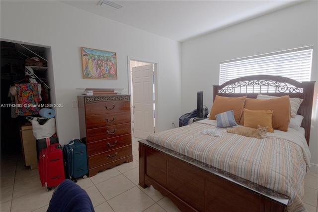 tiled bedroom with a closet