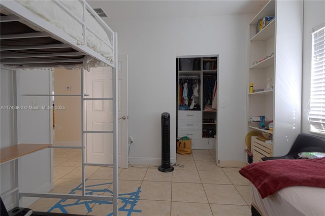 bedroom featuring a closet and light tile patterned floors