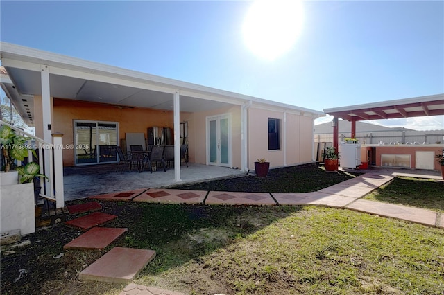 back of house with a pergola, a yard, and a patio area