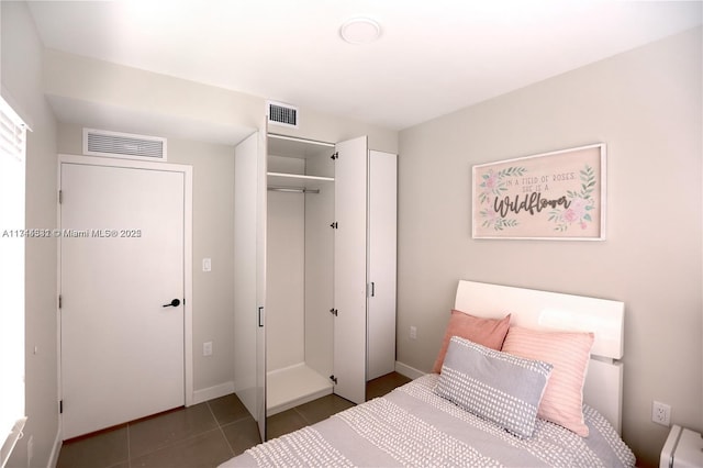 tiled bedroom featuring a closet