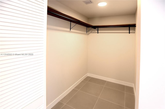 walk in closet featuring tile patterned flooring